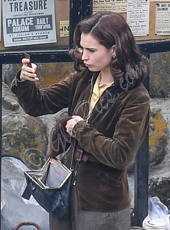 Lily James filming scenes from "Guernsey" at Clovelly Harbour
