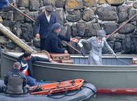 Lily James filming scenes from "Guernsey" at Clovelly Harbour
