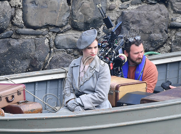 Lily James filming scenes from "Guernsey" at Clovelly Harbour