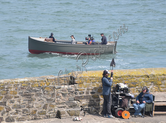 Lily James filming scenes from "Guernsey" at Clovelly Harbour