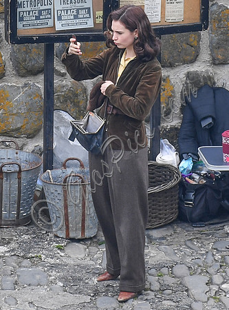 Lily James filming scenes from "Guernsey" at Clovelly Harbour