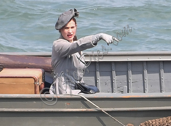 Lily James filming scenes from "Guernsey" at Clovelly Harbour