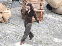 Lily James filming scenes from "Guernsey" at Clovelly Harbour