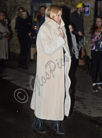 Kate Moss wearing calf length faux fur cream coat
