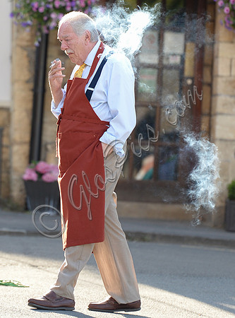 Sir Michael Gambon as Howard Mollison wearing blue pyjamas and monogrammed slippers