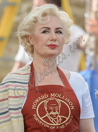Close up of Hetty Banes (Maureen Lowe) wearing red apron from Mollison's Deli