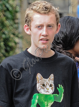 Close up of actor Joe Hurst wearing a black T shirt with cat logo