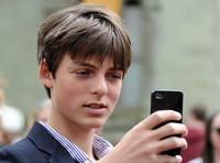 Head shot of Damien Hurley taking picture with phone