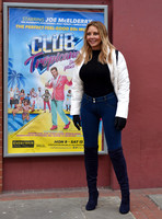 Carol Vorderman in skin tight jeans and a figure hugging black sweater