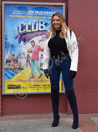Carol Vorderman in skin tight jeans and a figure hugging black sweater