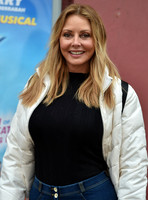 Carol Vorderman in skin tight jeans and a figure hugging black sweater