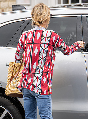 Kate Moss with loose hair knot, wearing denims, multi coloured top and ballet pumps