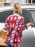 Kate Moss with loose hair knot, wearing denims, multi coloured top and ballet pumps