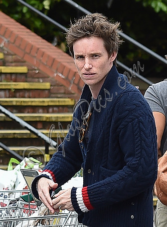 Eddie Redmayne wearing blue cardigan, skinny jeans and trainers on shopping trip to Stroud