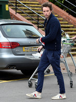 Eddie Redmayne wearing blue cardigan, skinny jeans and trainers on shopping trip to Stroud