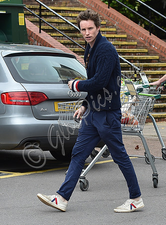 Eddie Redmayne wearing blue cardigan, skinny jeans and trainers on shopping trip to Stroud
