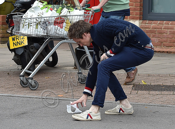 Eddie Redmayne wearing blue cardigan, skinny jeans and trainers on shopping trip to Stroud