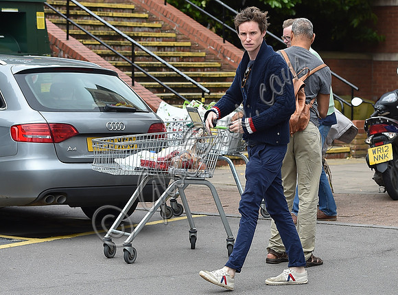 Eddie Redmayne wearing blue cardigan, skinny jeans and trainers on shopping trip to Stroud