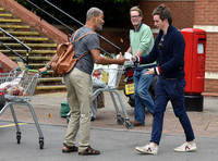 Eddie Redmayne wearing blue cardigan, skinny jeans and trainers on shopping trip to Stroud