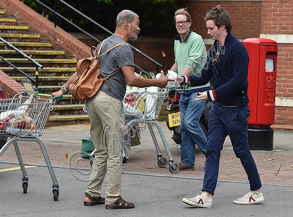Eddie Redmayne wearing blue cardigan, skinny jeans and trainers on shopping trip to Stroud