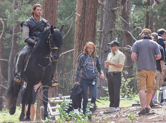 Chris Hemsworth on horseback with others, crew members