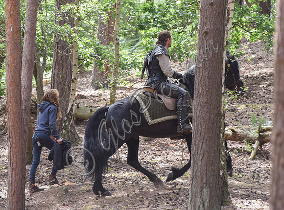 Chris Hemsworth on horseback with others, crew members