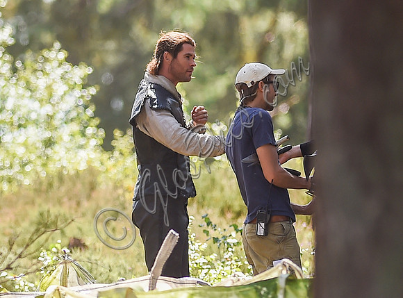 Chris Hemsworth on horseback with others, crew members