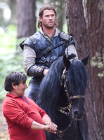 Chris Hemsworth on horseback with horse master alongside