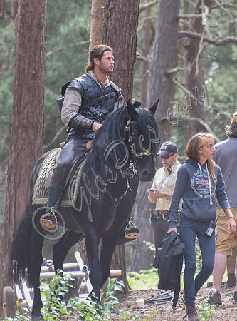 Chris Hemsworth on horseback with others, crew members