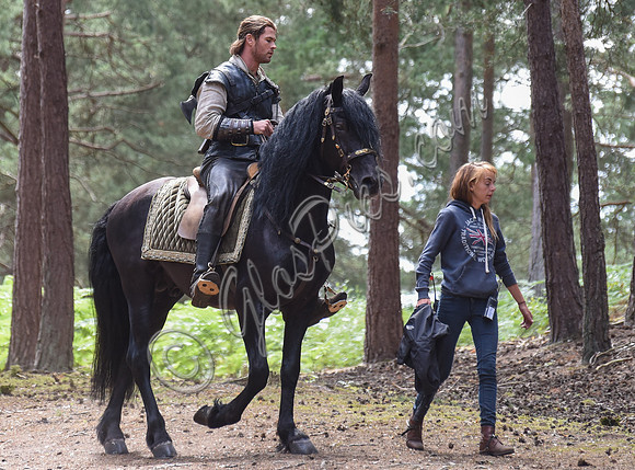 Chris Hemsworth on horseback with others, crew members