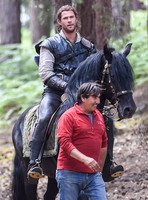 Chris Hemsworth on horseback with horse master alongside