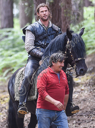 Chris Hemsworth on horseback with horse master alongside
