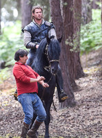 Chris Hemsworth on horseback with horse master alongside