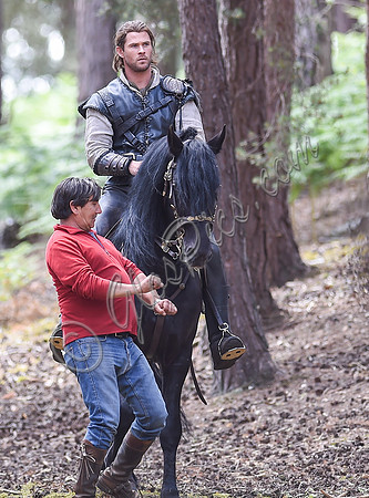 Chris Hemsworth on horseback with horse master alongside