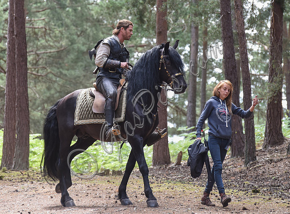 Chris Hemsworth on horseback with others, crew members