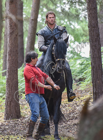 Chris Hemsworth on horseback with horse master alongside