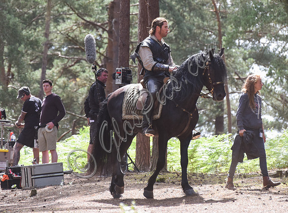 Chris Hemsworth on horseback with others, crew members