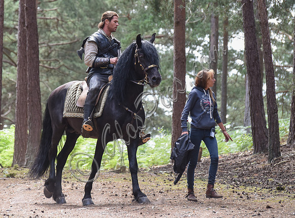 Chris Hemsworth on horseback with others, crew members
