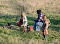 Unknown group of characters on set in field by campfire