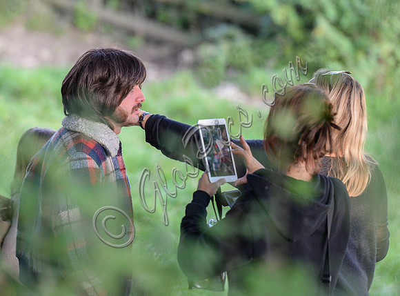 Character being photographed for continuity