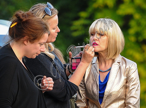 Ashley Jenson having make-up retouched with others