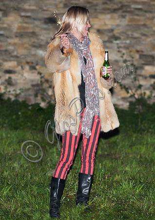 Kate  Moss with bottle of beer and a sparkler
