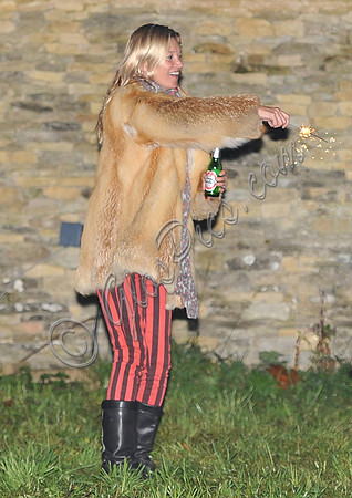 Kate  Moss with bottle of beer and a sparkler