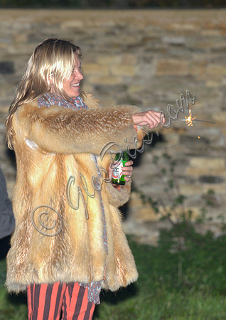 Kate  Moss with bottle of beer and a sparkler