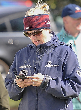 Zara Tindall texting wearing Musto headband and jacket