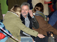Kate Moss with sparkler, side view in crowd, amongst others