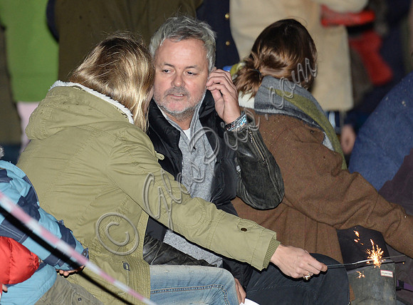 Kate Moss with sparkler, side view in crowd, amongst others