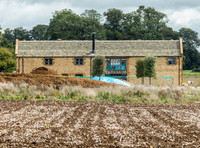 exterior building views of Beckham's triple barn conversion