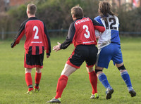Back shot Stuart 'Psycho' Pearce No. 3 shirt with No 2 player for Longford AFC v Pearce grabbing arm of Wotton Rovers player with long hair wearing black headband