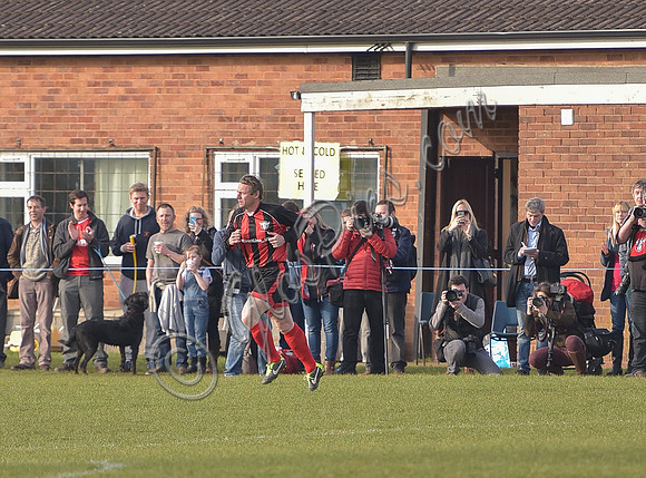 Stuart 'Psycho' Pearce running out onto the pitch as sub for Longford AFC , supporters and photographers watching from pitchside.